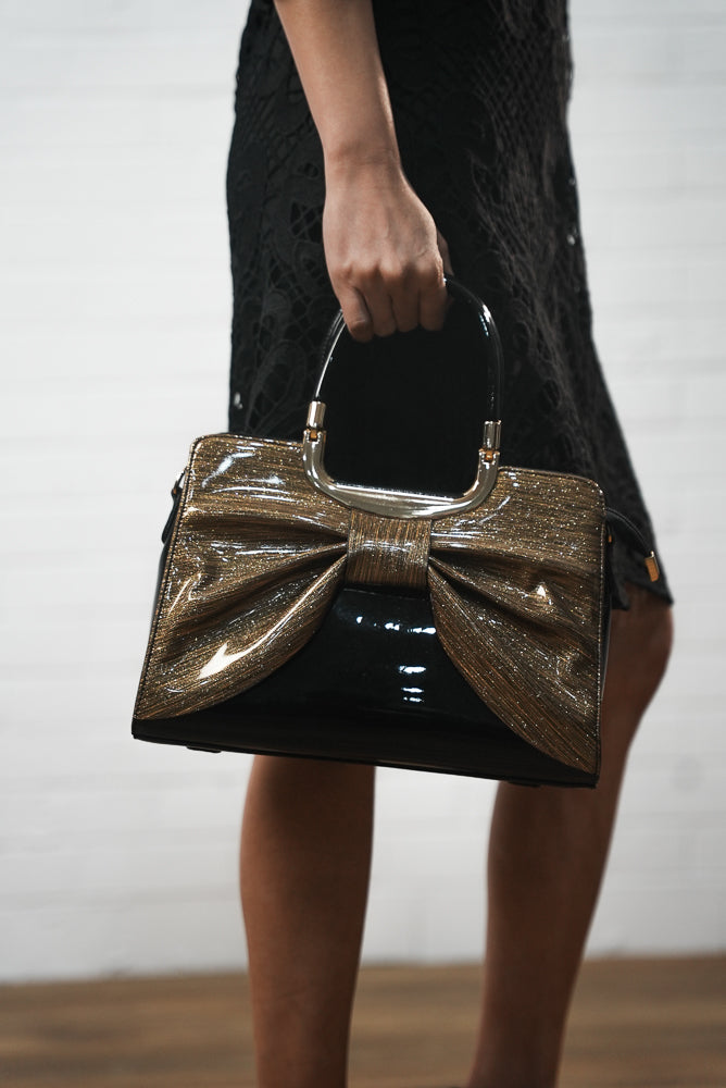 gold Faux leather shimmer bow handbag | Runway Secrets